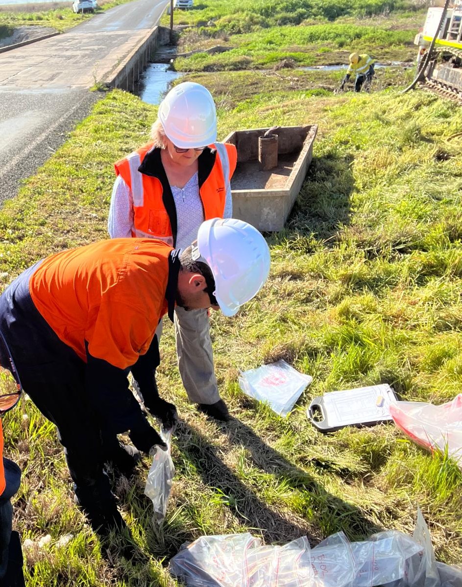 Geoporte engineers bagging soil samples beside a road on site